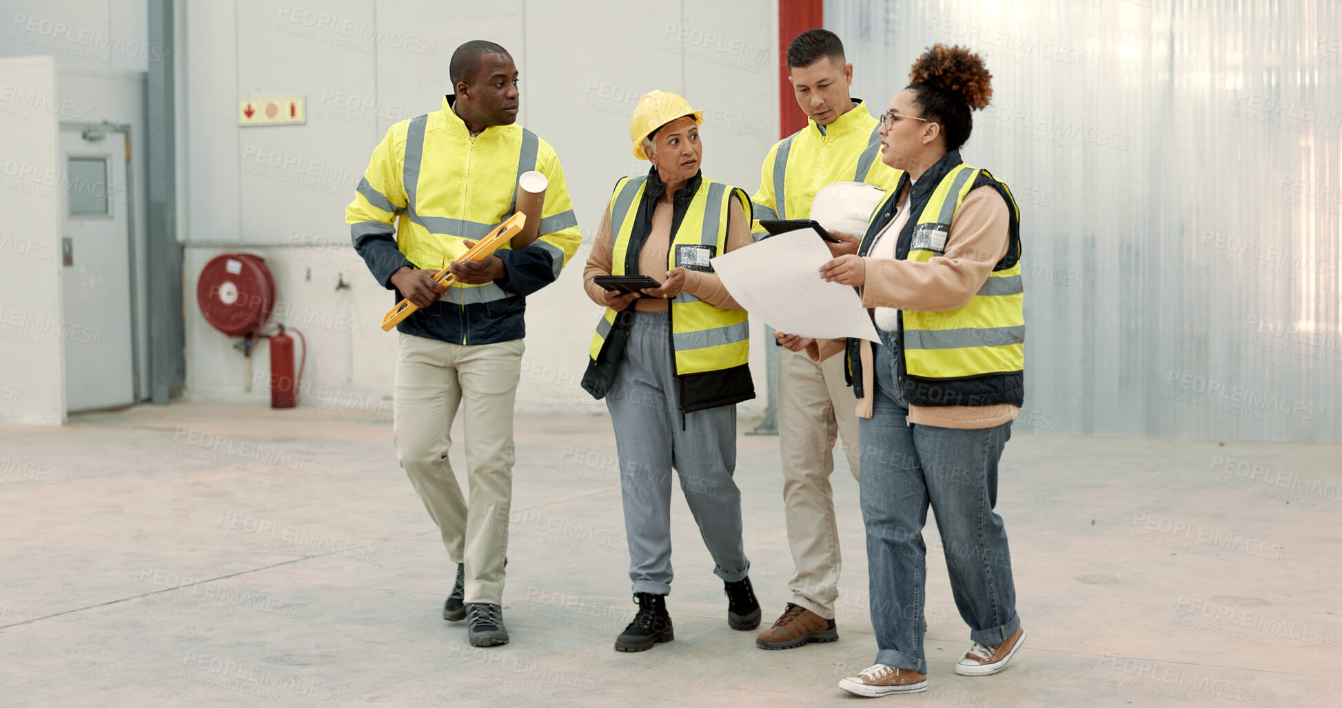 Buy stock photo Construction site, blueprint and business people walking in a building planning, discussion or renovation idea. Architecture, project management and engineer team in warehouse for design conversation