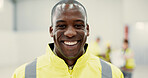 Smile, happy and portrait of black man construction worker standing with confidence in a warehouse. Positive, pride and young African industrial employee at an indoor site for maintenance or repairs.