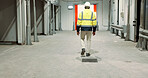 Warehouse, back of man and engineer walking at empty industrial plant, manufacturing production or construction. Factory, rear view and worker or technician check storage, distribution and logistics