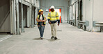 Engineer woman, man and walking in warehouse for planning discussion for manufacturing, logistics or industry. Teamwork, thinking and brainstorming for vision, supply chain and commerce in factory