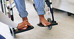 Hand, doctor and feet in wheelchair with help in home for recovery, exam and check progress for healthcare. Physiotherapist, nurse or caregiver for person with disability in house for rehabilitation