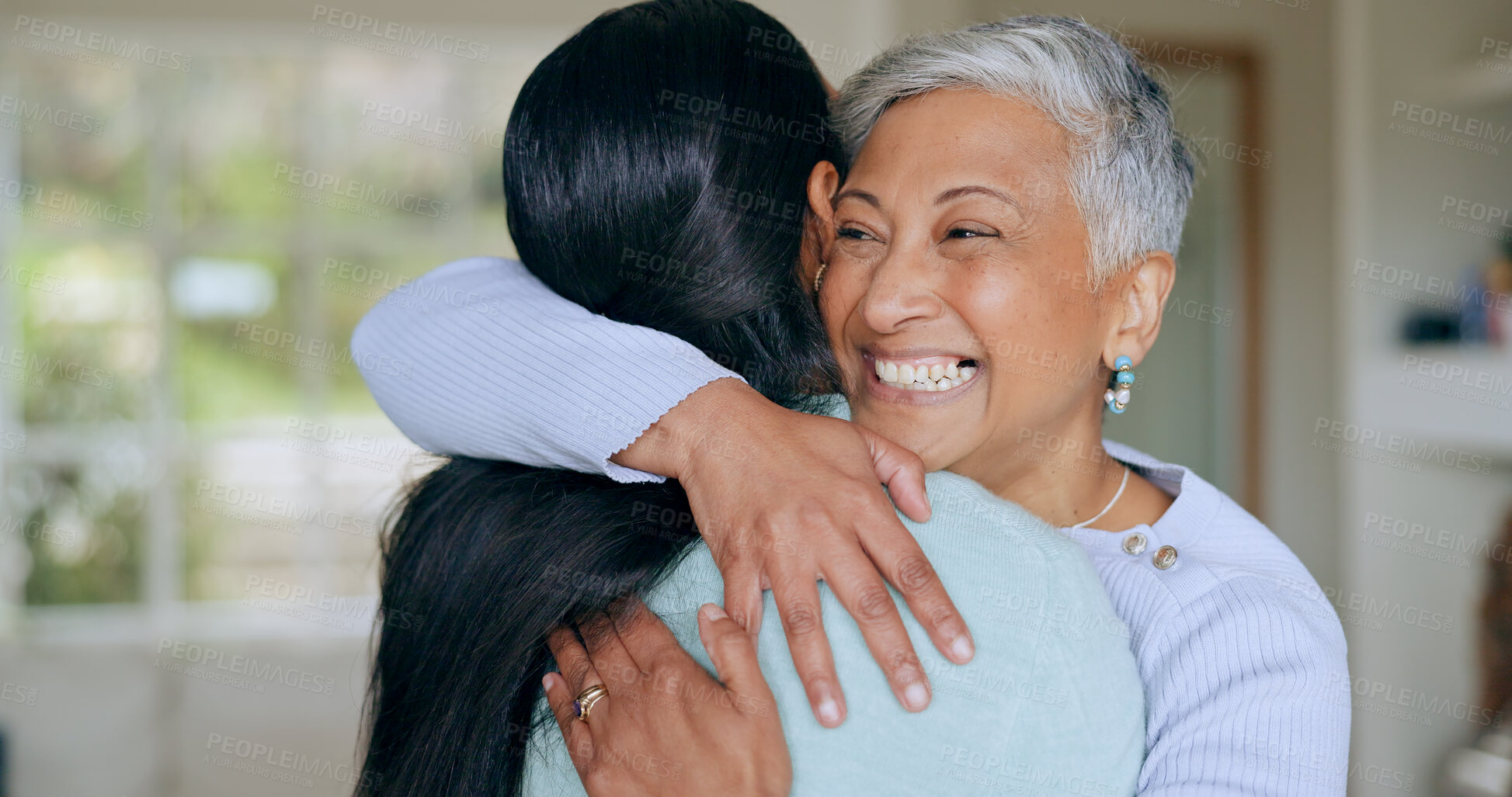 Buy stock photo Hug, happy and mother and daughter in home for bonding, relationship and smile together for love. Family, visit and mature mom embrace adult woman for mothers day, support and care in living room