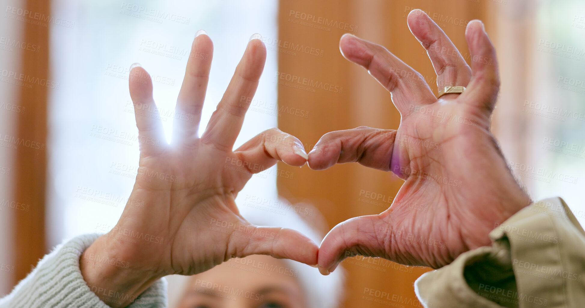 Buy stock photo Closeup, home and senior couple with heart hands, support and romance with retirement, relationship and care. Apartment, elderly man and old woman with symbol for love, marriage and romantic with joy