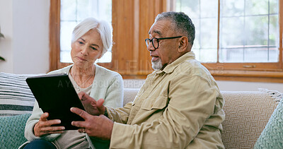 Buy stock photo Tablet, love and an elderly couple on a sofa in the living room of their home to search social media together. Diversity, app or technology with a senior man and woman in the apartment for retirement