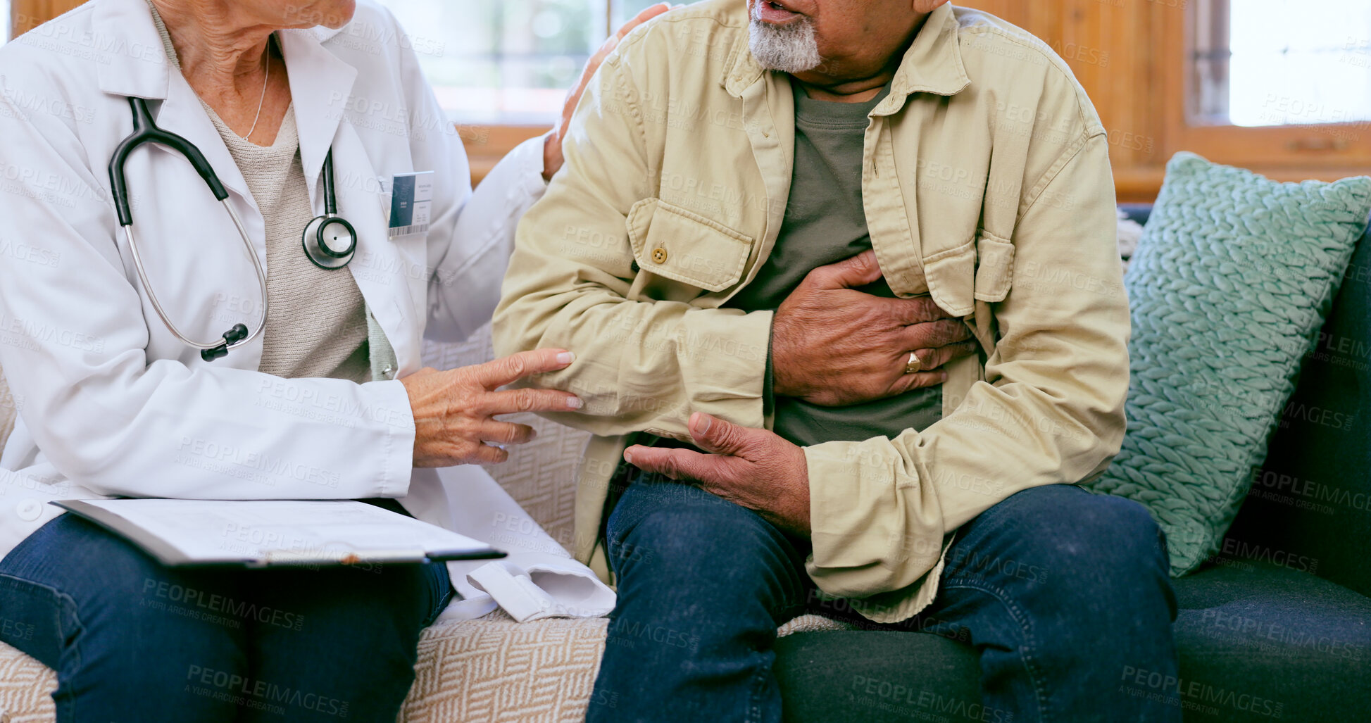 Buy stock photo Doctor, senior man and hand on chest for cardiology exam, consulting or advice for pain on sofa. Medic woman, elderly patient or check for cardiovascular system, lungs or breathing on couch at clinic