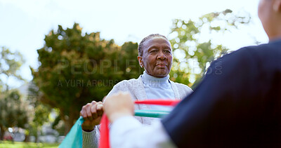 Buy stock photo Senior, woman and nurse with stretching band outdoor for exercise, workout or fitness in a park. People, professional or caregiver or physical activity for physiotherapy, wellness or health in nature