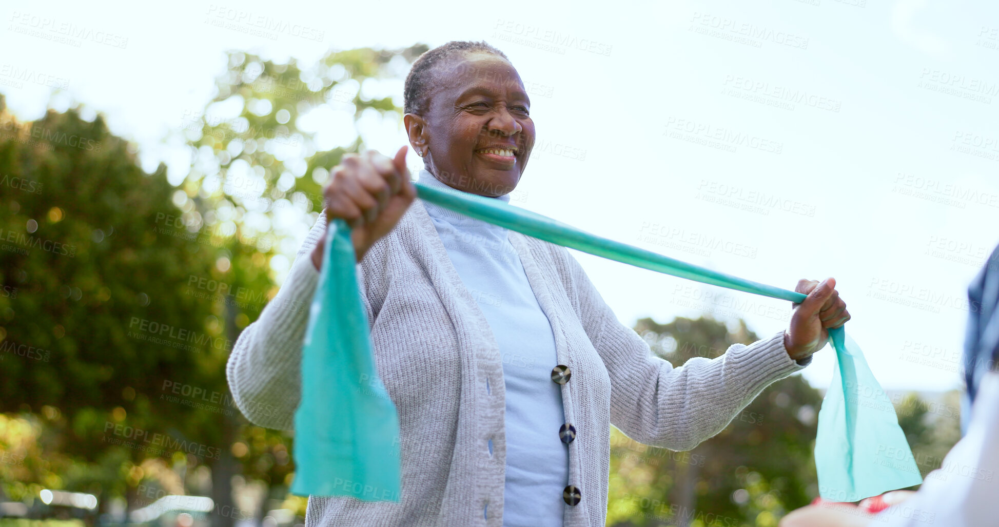 Buy stock photo Elderly, woman and physiotherapy for fitness with resistance band in park, outside or garden for wellness. Black person, smile and happy with results in mobility, recovery or rehabilitation of injury