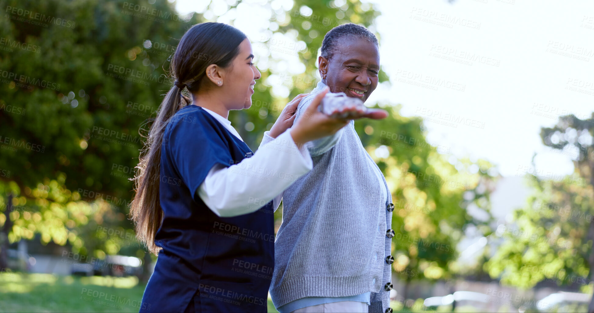 Buy stock photo Senior, woman and caregiver with arm stretching for exercise, workout or fitness in a park with smile. People, professional or nurse with activity for physiotherapy, wellness and health in nature