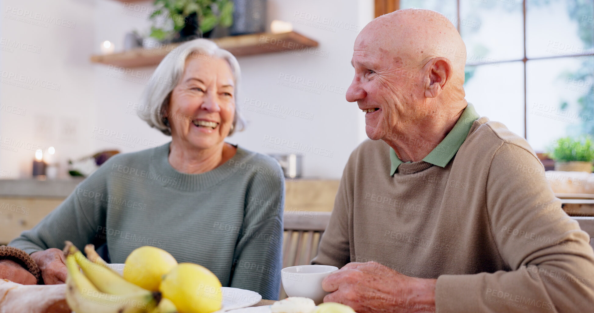 Buy stock photo Laughing, retirement and a senior couple drinking tea in the dining room of their home together in the morning. Smile, funny or conversation with an elderly man and woman in an apartment for romance