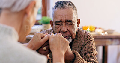 Buy stock photo Senior couple, holding hands and praying in home for religion, hope or love for mindfulness. Elderly man, woman and support for peace, prayer and gratitude for connection to God, holy spirit or faith
