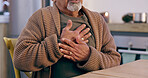 Hands, breathing and heart attack with a senior person in the dining room of a retirement home closeup. Healthcare, medical or emergency and an elderly adult with chest pain for cardiac arrest