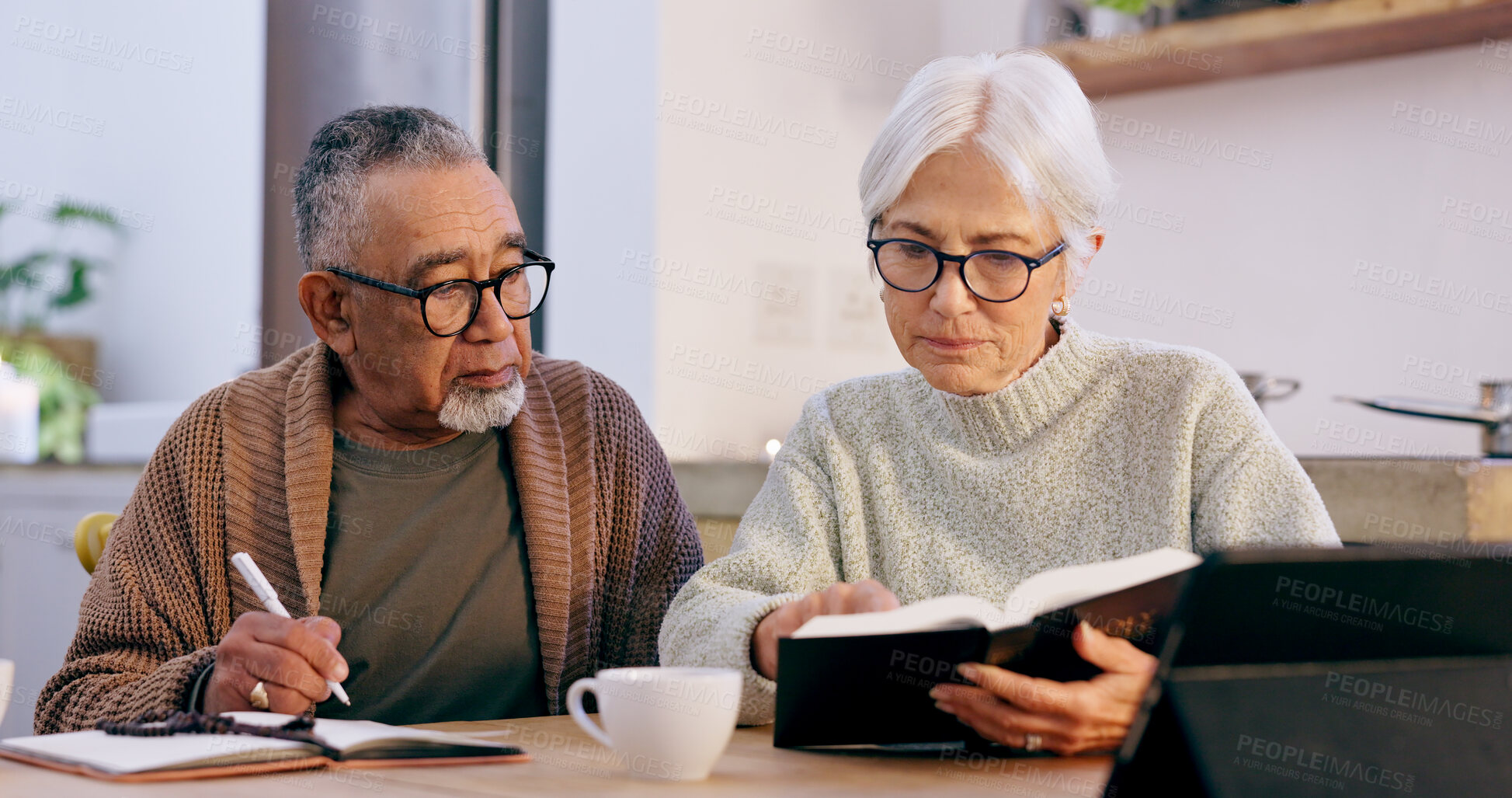 Buy stock photo Senior couple, bible study and home with reading, writing and thinking with faith, worship or knowledge. Elderly woman, old man and interracial marriage with religion, notebook or spiritual education
