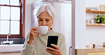Senior woman, tea and phone with reading, texting and communication on web, app and typing in home. Elderly lady, drink and coffee cup for espresso with smartphone, social network or notification