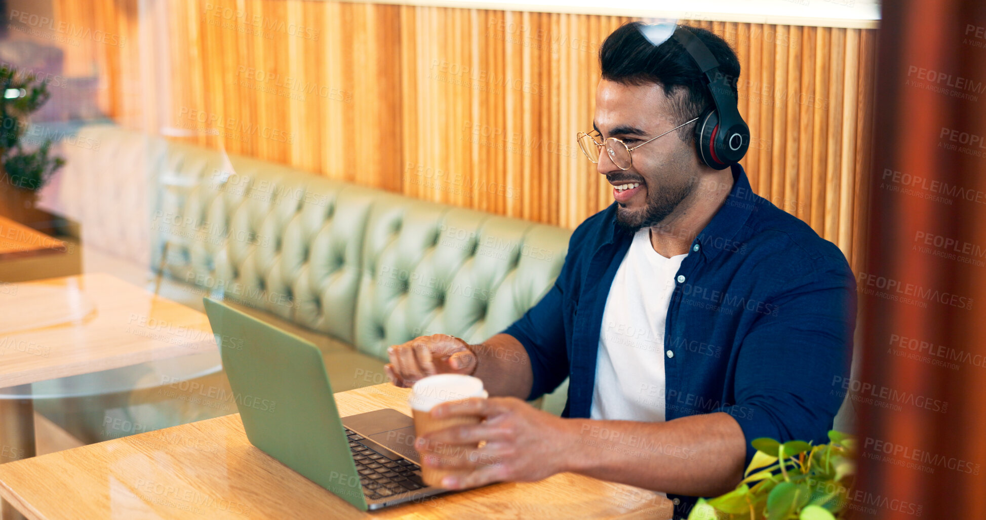 Buy stock photo Happy man in coffee shop with headphones, laptop and remote work, reading email and internet in restaurant. Computer, freelancer and copywriter in cafe, listening to music and drink in cup at table