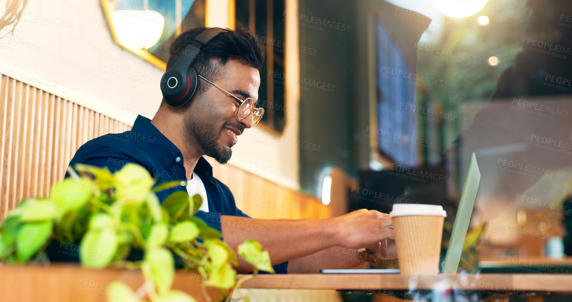 Buy stock photo Happy man in cafe with headphones, typing on laptop and remote work, reading email and web in restaurant. Computer, freelancer smile and copywriter in coffee shop, listen to music and radio at table