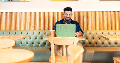 Man in cafe, typing on laptop and remote work, reading email and writing blog, article and research in restaurant. Computer, freelancer and editor in coffee shop, store and tech for internet at table