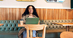 Happy woman in cafe, typing on laptop and remote work, reading email or writing blog, article or search on technology. Computer, freelancer or copywriting in coffee shop, store or restaurant at table