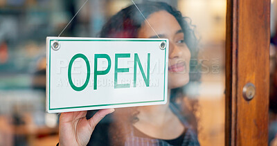 Woman, small business or open sign on window in coffee shop or restaurant for service or advertising. Ready, start or entrepreneur holding board, poster or welcome for message in retail store or cafe