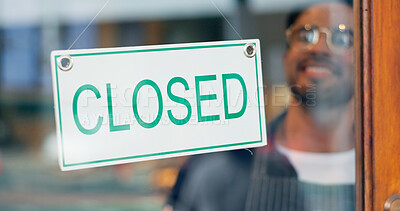 Happy man, small business or closed sign on window in coffee shop or restaurant for end of service. Closing time, smile or manager with board, poster or message in retail store or cafe for notice