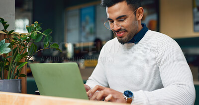 Man, typing and laptop in cafe for remote work, research or networking for business with smile. Face, person and happiness with technology in coffee shop for copywriting, internet and freelancer