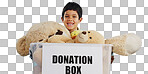 Boy in studio with toys, donation in box and smile for children, social charity and hope in kindness. Care, donate and happy kindergarten child with teddy bear package at kids ngo on blue background.