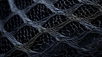 Macro fabric or textile pattern on a black background. Detailed fabric pattern