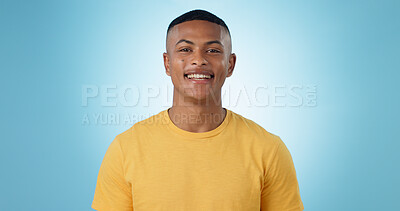 Buy stock photo Portrait, young man and smile in studio with confidence, good mood or casual fashion isolated on blue background. Happy gen z model with cheerful personality, pride and mockup space in Puerto Rico 