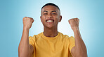 Man, portrait and excited for success with fist in studio to celebrate deal, promotion or yes to winning lottery on blue background. Happy model, giveaway prize winner or reward for bonus achievement