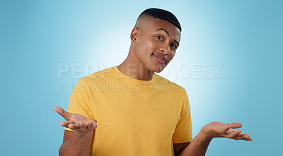 Buy stock photo Confused, portrait and man shrug in studio with why hands on blue background space. Doubt, face and model with dont know emoji for choice, decision or palm scale, questions or asking body language