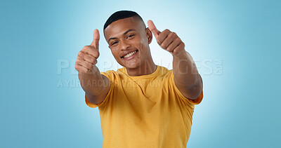 Buy stock photo Thumbs up, portrait and man in studio for success, winning deal and celebrate achievement on blue background. Happy model, emoji and like sign for feedback, voting yes and thank you for excellence 