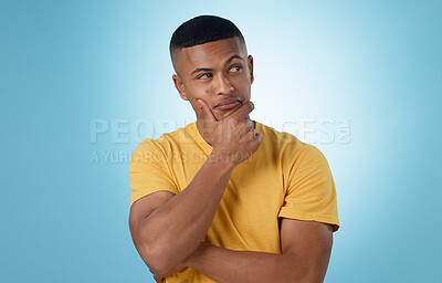 Buy stock photo Man, face and thinking in decision, choice or planning for idea or memory against a blue studio background. Unsure male person or curious model in wonder, remember or solution in why, emoji or mockup