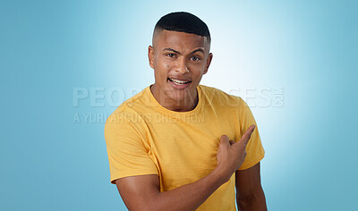 Buy stock photo Pointing, question and portrait of man in a studio with mockup for marketing, advertising or promotion. Confused, thinking and young male person with a show hand gesture isolated by blue background.