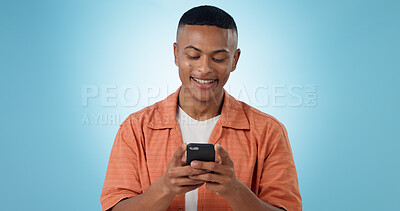 Buy stock photo Happy, social media and man with a smartphone, typing and connection on a blue background. Person, guy and model with a cellphone, mobile user and reaction with website information, contact and app