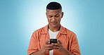 Expression, confused and man with a smartphone, typing and connection on a blue background. Person, guy and model with a cellphone, mobile user and reaction with doubt, error 404 and contact with app