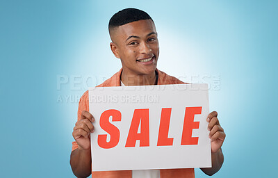 Buy stock photo Portrait, man or poster with sale, promotion or discount deal with sign on blue background. Face, person or model with paper, information or presentation with announcement, saving or opportunity