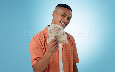 Buy stock photo Happy man, winner and money fan with success, bonus or winning in competition, college loan or cashback in studio. Portrait of student with cash, savings and scholarship funding on a blue background