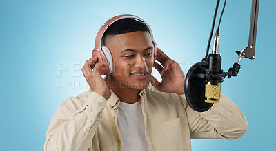 Buy stock photo Artist man, headphones and mic in studio with thinking, ideas and creativity for song by blue background. Musician, person and microphone with recording, production and performance with singing voice