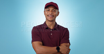 Buy stock photo Delivery man, arms crossed or portrait for distribution or mockup space on blue background. Professional, retail supply chain or happy logistics worker for shipping or courier service in studio