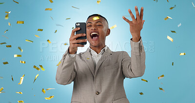 Buy stock photo Business man, phone and winning with confetti celebration, stock market news or competition winner in studio. Young trader in wow, surprise and excited for profit or sale on mobile on blue background