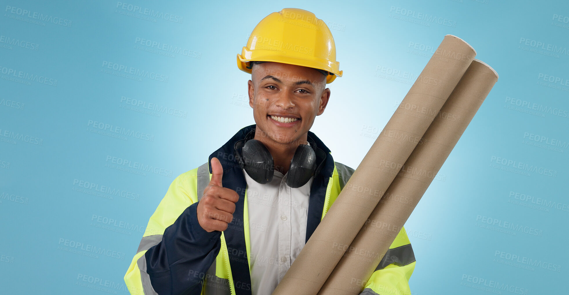 Buy stock photo Engineering, man and thumbs up for architecture success, renovation and design planning with blueprint in studio. Portrait of construction worker or contractor with like emoji on a blue background