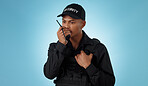 Security guard, walkie talkie and man with communication in a studio with police and law enforcement. Blue background, surveillance and officer with discussion and talking for safety and danger