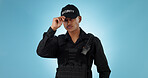Security guard, confidence and man with employee in a studio with police and law enforcement. Blue background, surveillance and officer with hat and helping for safety and danger of bodyguard worker