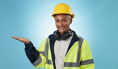 Buy stock photo Happy, construction worker and portrait with hand advertising, promotion or mockup in blue background. Happy, face and builder show safety announcement, presentation or branding space in studio