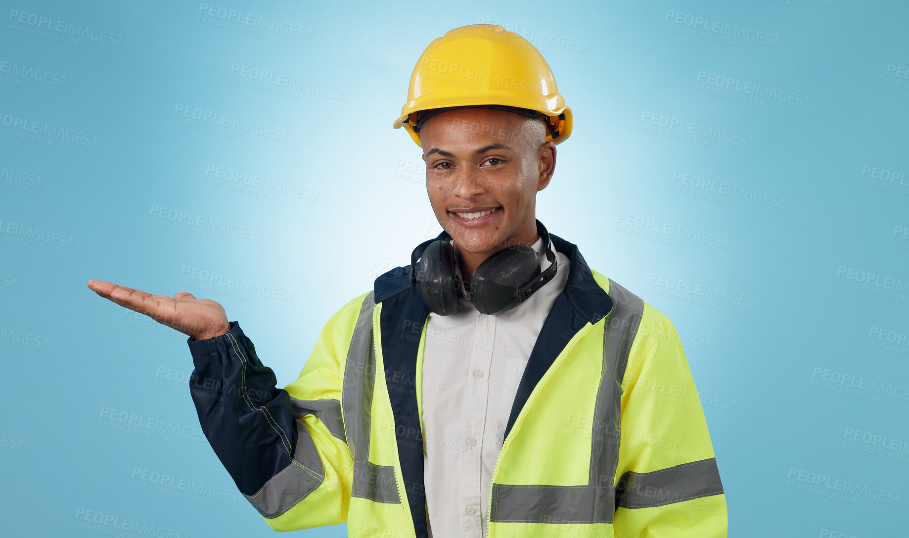 Buy stock photo Happy, construction worker and portrait with hand advertising, promotion or mockup in blue background. Happy, face and builder show safety announcement, presentation or branding space in studio
