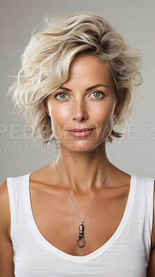 Vertical portrait of attractive mature woman on backdrop. Fashion, editorial concept.
