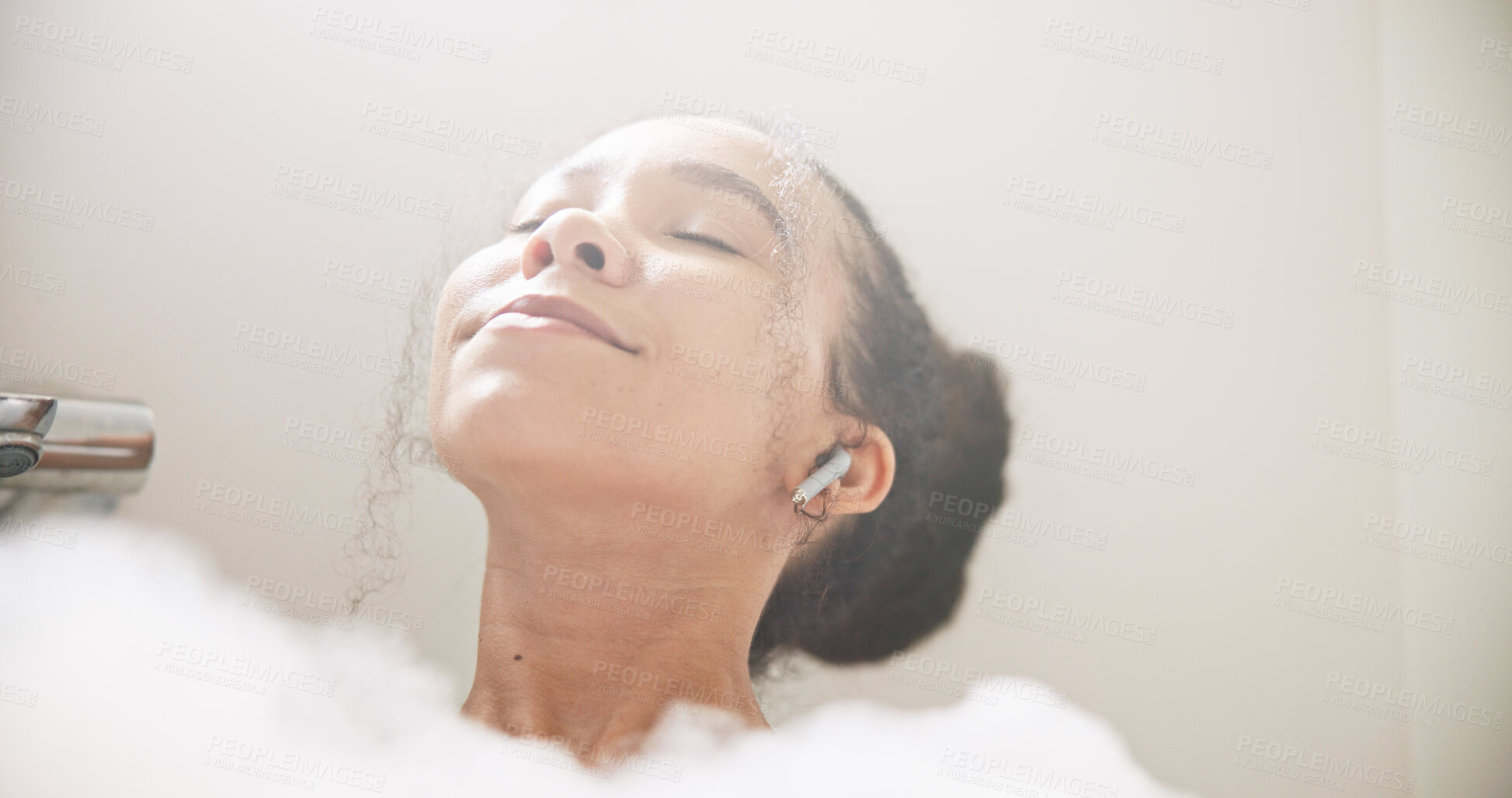 Buy stock photo Music, face or happy woman in a bath in hotel cleaning, grooming or body care in soap foam. Relax, earphones or calm lady lying in water in spa, home or bathroom streaming or listening to radio song