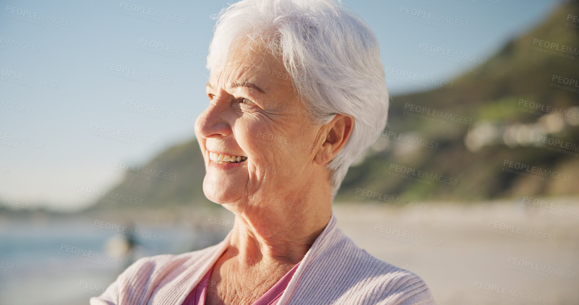 Buy stock photo Senior woman, smile and sunset on beach to relax with peace outdoor in nature, sea and elderly female person with mindfulness. Happy, face and old lady thinking by a ocean on holiday in retirement