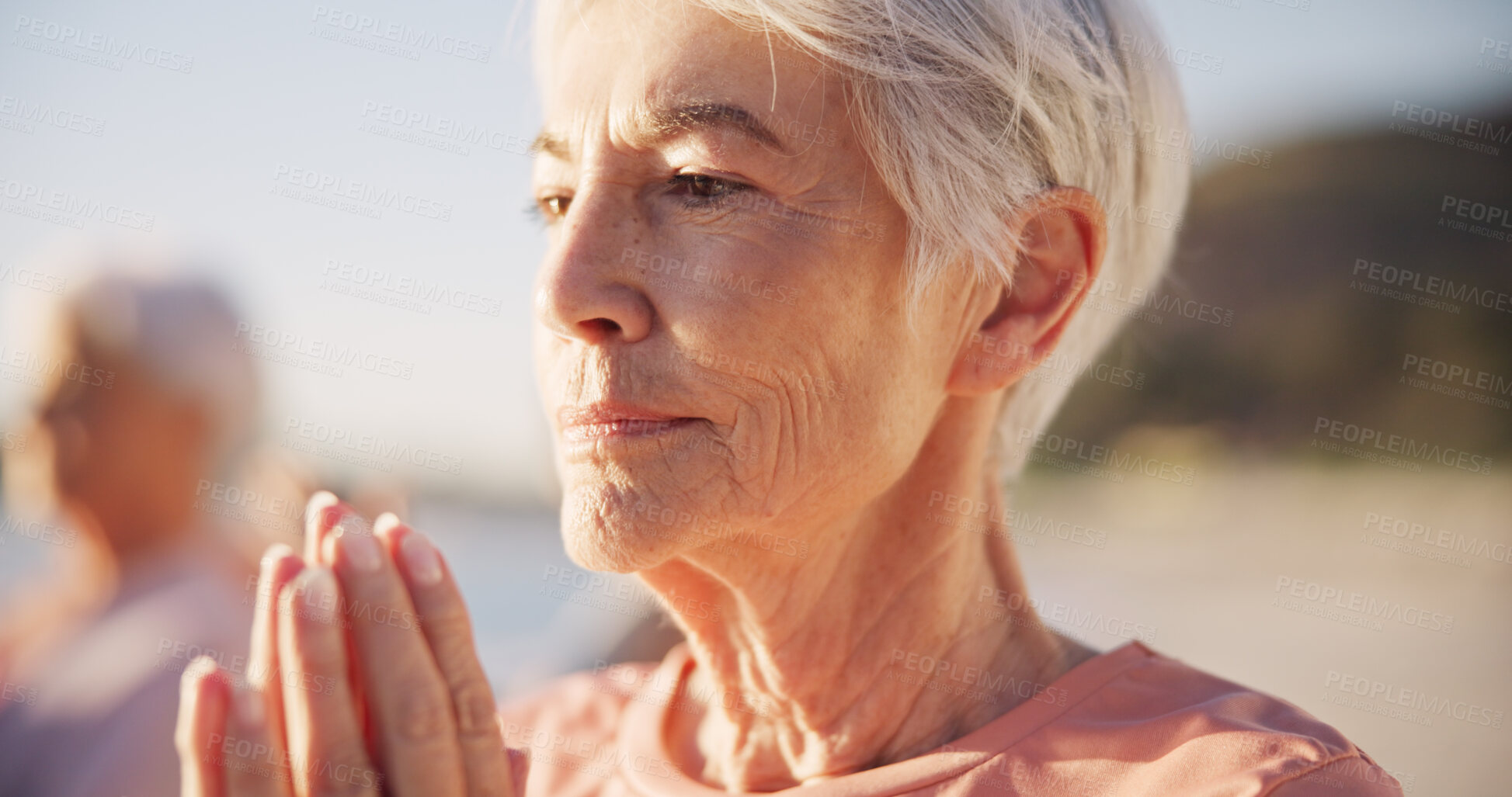 Buy stock photo Beach yoga class, face or senior woman doing exercise, wellness breathing and learning mindfulness workout in nature. Freedom, relax or elderly person pose, morning fitness and coach teaching pilates