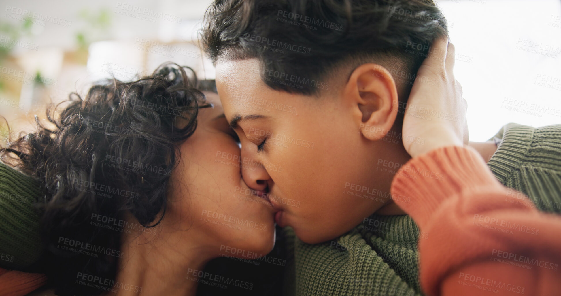 Buy stock photo Love, home face and lesbian couple kiss, intimate and care for marriage, non binary or transgender partner on lounge sofa. LGBT, trust and same sex people bonding, support and enjoy time together