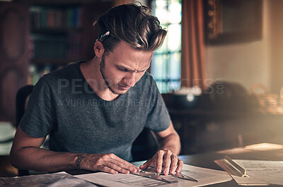 Buy stock photo Shot of a diligent young student doing a homework assignment at home
